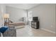 Cozy bedroom featuring neutral tile, a twin bed, and a patterned chair near a window at 1158 Oak Bluff Dr, Davenport, FL 33837
