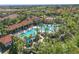 Aerial view showcasing the expansive community pool with lush tropical landscaping at 1158 Oak Bluff Dr, Davenport, FL 33837