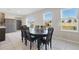 Bright dining area with a dark wood table set perfect for Gathering meals and entertaining at 1158 Oak Bluff Dr, Davenport, FL 33837