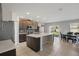 Open-concept kitchen featuring dark cabinetry, stainless steel appliances, and a large center island at 1158 Oak Bluff Dr, Davenport, FL 33837