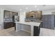 Modern kitchen with stainless steel appliances, dark cabinets, and a mosaic backsplash at 1158 Oak Bluff Dr, Davenport, FL 33837