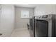 Modern laundry room featuring updated washer and dryer at 1158 Oak Bluff Dr, Davenport, FL 33837