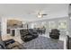 Comfortable living space showcasing furniture, tile flooring and an open flow to the kitchen and dining area at 1158 Oak Bluff Dr, Davenport, FL 33837