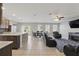 Open-concept living area featuring a modern kitchen, dining space, and cozy seating around a fireplace at 1158 Oak Bluff Dr, Davenport, FL 33837