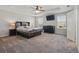 Spacious main bedroom features carpet, a tray ceiling with fan, and multiple windows for natural light at 1158 Oak Bluff Dr, Davenport, FL 33837