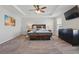Main bedroom with a coffered ceiling, TV and carpet flooring, offering a serene and relaxing retreat at 1158 Oak Bluff Dr, Davenport, FL 33837