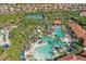 Aerial view of community pool featuring mature palm trees, lounge chairs, and Gathering recreational facilities at 1158 Oak Bluff Dr, Davenport, FL 33837