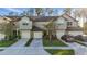 Attractive townhome exterior with attached garages, neutral paint, well-kept lawns, and driveways at 1284 Pavia Dr, Apopka, FL 32703