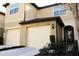 Charming townhouse featuring attached garages, manicured landscaping, and a welcoming entrance at 1284 Pavia Dr, Apopka, FL 32703