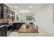 Well-lit kitchen showcasing dark wood cabinets, granite countertops, a center island, and stainless steel appliances at 1284 Pavia Dr, Apopka, FL 32703