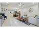 Open-concept living room boasts tile flooring, a modern sectional, and seamless flow to the kitchen at 1284 Pavia Dr, Apopka, FL 32703