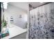 Bright bathroom features a shower with stylish curtain and an elegant sink with a quartz countertop at 140 Pinesong Dr, Casselberry, FL 32707