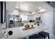 Modern kitchen with stainless steel appliances, white cabinets, and a breakfast bar at 140 Pinesong Dr, Casselberry, FL 32707