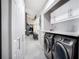 Convenient laundry area featuring modern appliances, storage cabinets, and easy access to the home at 140 Pinesong Dr, Casselberry, FL 32707