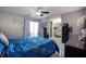 Comfortable main bedroom featuring sliding glass door access to patio, ceiling fan, and en suite bathroom at 140 Pinesong Dr, Casselberry, FL 32707