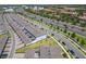 Aerial view of modern townhomes near a roadway, showcasing community layout and access at 14432 Orchid Island Dr, Orlando, FL 32827