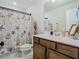 Cozy bathroom with a nautical-themed shower curtain and wood vanity at 14432 Orchid Island Dr, Orlando, FL 32827