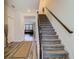 Open entryway leading to carpeted stairs and a view into the spacious living area at 14432 Orchid Island Dr, Orlando, FL 32827
