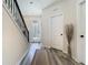 Bright entryway featuring modern floors, white trim, and staircase with iron railing at 14432 Orchid Island Dr, Orlando, FL 32827