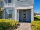 Close up of a blue townhome with well-maintained landscaping and brick paver walkway at 14432 Orchid Island Dr, Orlando, FL 32827