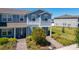 Charming blue townhome with well-kept landscaping and brick paver walkway at 14432 Orchid Island Dr, Orlando, FL 32827