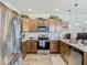 Kitchen with wood cabinets, stainless appliances, light countertops, and backsplash at 14432 Orchid Island Dr, Orlando, FL 32827