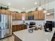 Kitchen with wood cabinets, stainless appliances, light countertops and center island at 14432 Orchid Island Dr, Orlando, FL 32827