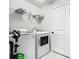 Clean laundry area with a side-by-side washer and dryer and overhead shelving at 14432 Orchid Island Dr, Orlando, FL 32827