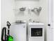 Laundry room with front loading washer and dryer and overhead storage at 14432 Orchid Island Dr, Orlando, FL 32827