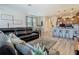 Relax in the spacious living room that blends seamlessly into the kitchen, perfect for modern living at 14432 Orchid Island Dr, Orlando, FL 32827