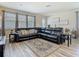 Open living space boasts stylish decor, with hardwood floors and a comfortable leather sectional at 14432 Orchid Island Dr, Orlando, FL 32827