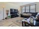 Bright and airy living room features hardwood floors and a cozy leather sectional, perfect for relaxation at 14432 Orchid Island Dr, Orlando, FL 32827