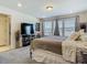 Serene main bedroom featuring plush carpet, natural light, and neutral decor for a calming retreat at 14432 Orchid Island Dr, Orlando, FL 32827