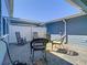 Relax in this home's private brick patio featuring rocking chairs and view of the blue two-story home at 14432 Orchid Island Dr, Orlando, FL 32827