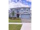 Beautiful two-story home with a well-manicured lawn and a two-car garage at 1584 Plunker Dr, Davenport, FL 33896