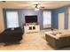 Bright living room featuring a large TV, comfortable seating, and tiled floors at 1584 Plunker Dr, Davenport, FL 33896
