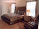 Inviting bedroom features a tufted headboard, decorative pillows, and lots of natural light at 1584 Plunker Dr, Davenport, FL 33896