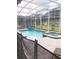 Beautiful screened pool and spa area with lush landscaping for privacy at 1584 Plunker Dr, Davenport, FL 33896