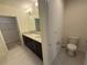 Bathroom featuring double vanity, walk-in closet and tiled flooring at 15872 Moonlight Bay St, Winter Garden, FL 34787