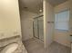 Bathroom featuring a glass-enclosed shower with tiled flooring at 15872 Moonlight Bay St, Winter Garden, FL 34787