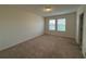 Bedroom with neutral carpet and walls, and a pair of windows providing ample natural light at 15872 Moonlight Bay St, Winter Garden, FL 34787