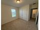 Bright bedroom featuring a window and closet with double doors at 15872 Moonlight Bay St, Winter Garden, FL 34787