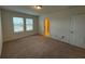 Bedroom with carpet, two windows and door at 15872 Moonlight Bay St, Winter Garden, FL 34787