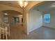 Inviting foyer boasts light walls and floors with an arched opening to the living area and view of the stairway at 15872 Moonlight Bay St, Winter Garden, FL 34787