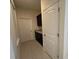 Hallway with tile flooring, built-in cabinetry, and white doors at 15872 Moonlight Bay St, Winter Garden, FL 34787