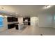Open concept kitchen with island, granite counters, dark cabinets, and stainless steel appliances at 15872 Moonlight Bay St, Winter Garden, FL 34787