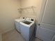 Bright laundry room featuring modern washer and dryer appliances at 15872 Moonlight Bay St, Winter Garden, FL 34787