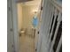 Clean powder room with pedestal sink and soft lighting, conveniently located near staircase at 15872 Moonlight Bay St, Winter Garden, FL 34787