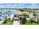 Aerial view of a two-story home with a lake view, well-maintained landscaping, and a spacious yard at 1628 Thetford Cir, Orlando, FL 32824