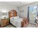 Serene bedroom features wood furnishings, soft bedding, and a peaceful ambiance, perfect for rest and relaxation at 1628 Thetford Cir, Orlando, FL 32824